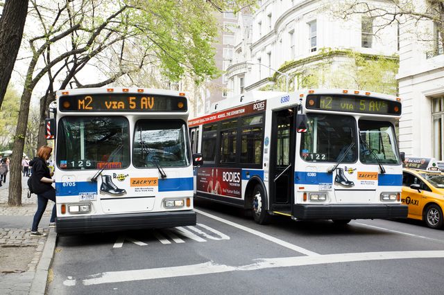 Two buses on Fifth Avenue in Manhattan.